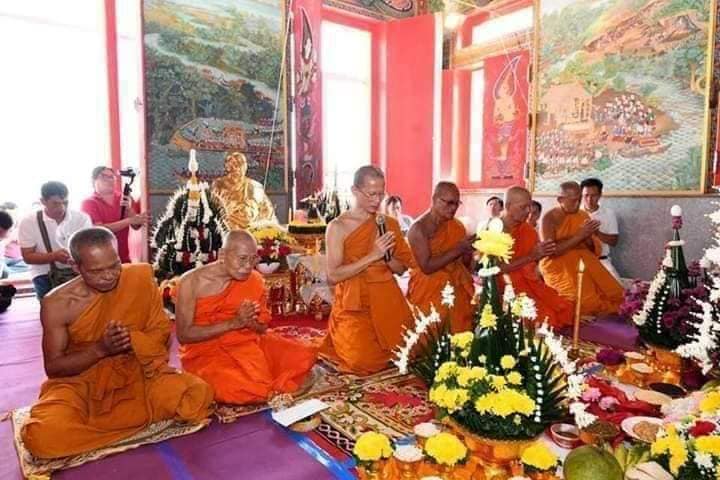 Thai Buddhist monks performing a temple blessing ceremony with floral offerings and Luang Pu Moon ritual knife