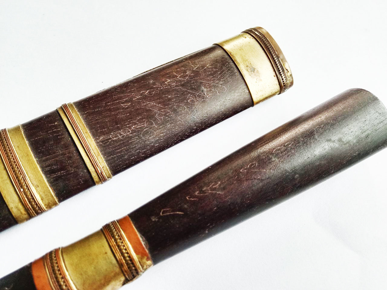 Closeup of two wooden scabbards with brass fittings for Luang Pu Moon ritual knife by Thai Blessing Co