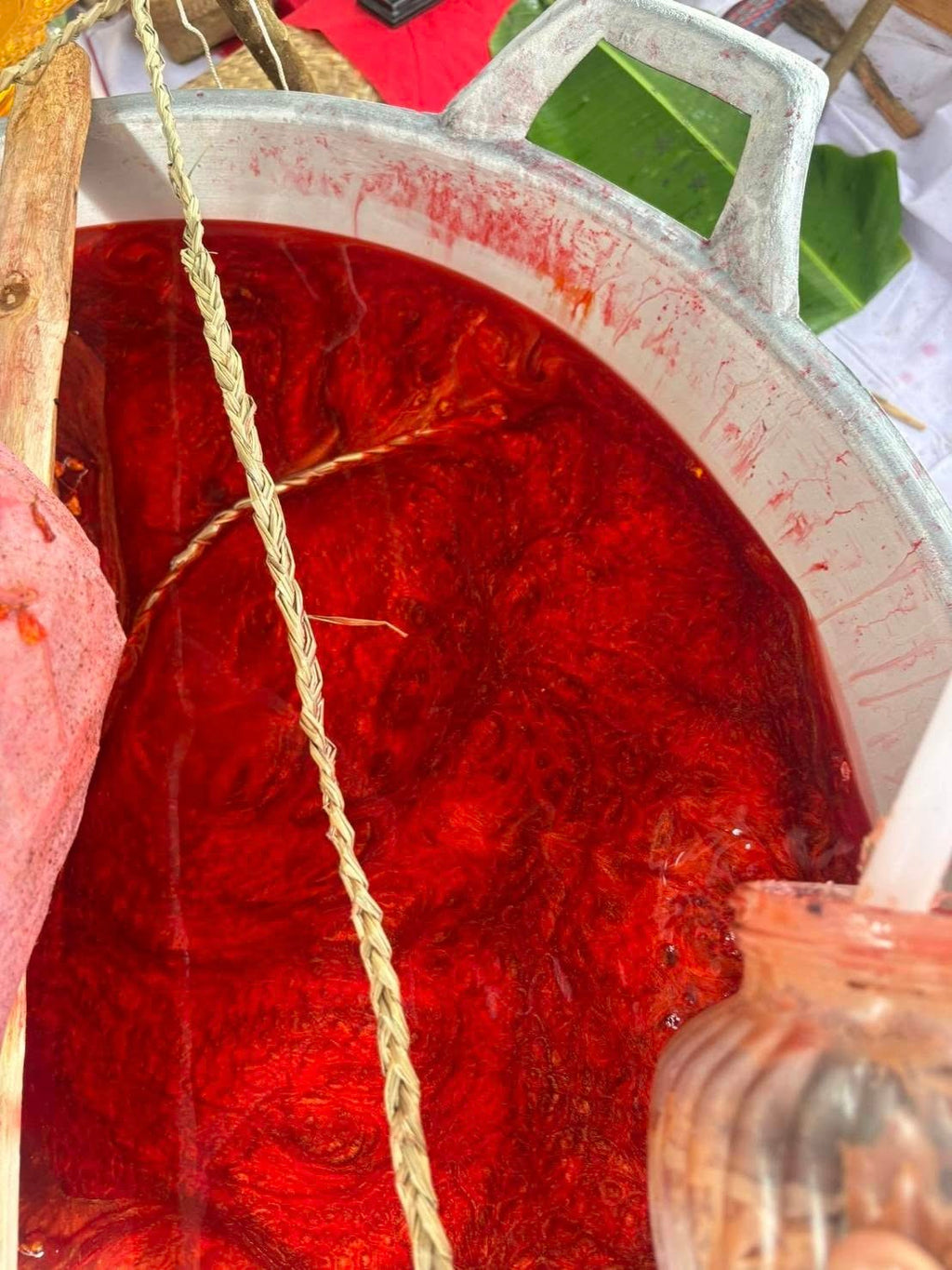 Thai Blessing Co ritual pot with swirling red sacred wax and braided cord used to create Luuk Sawat sacred charm