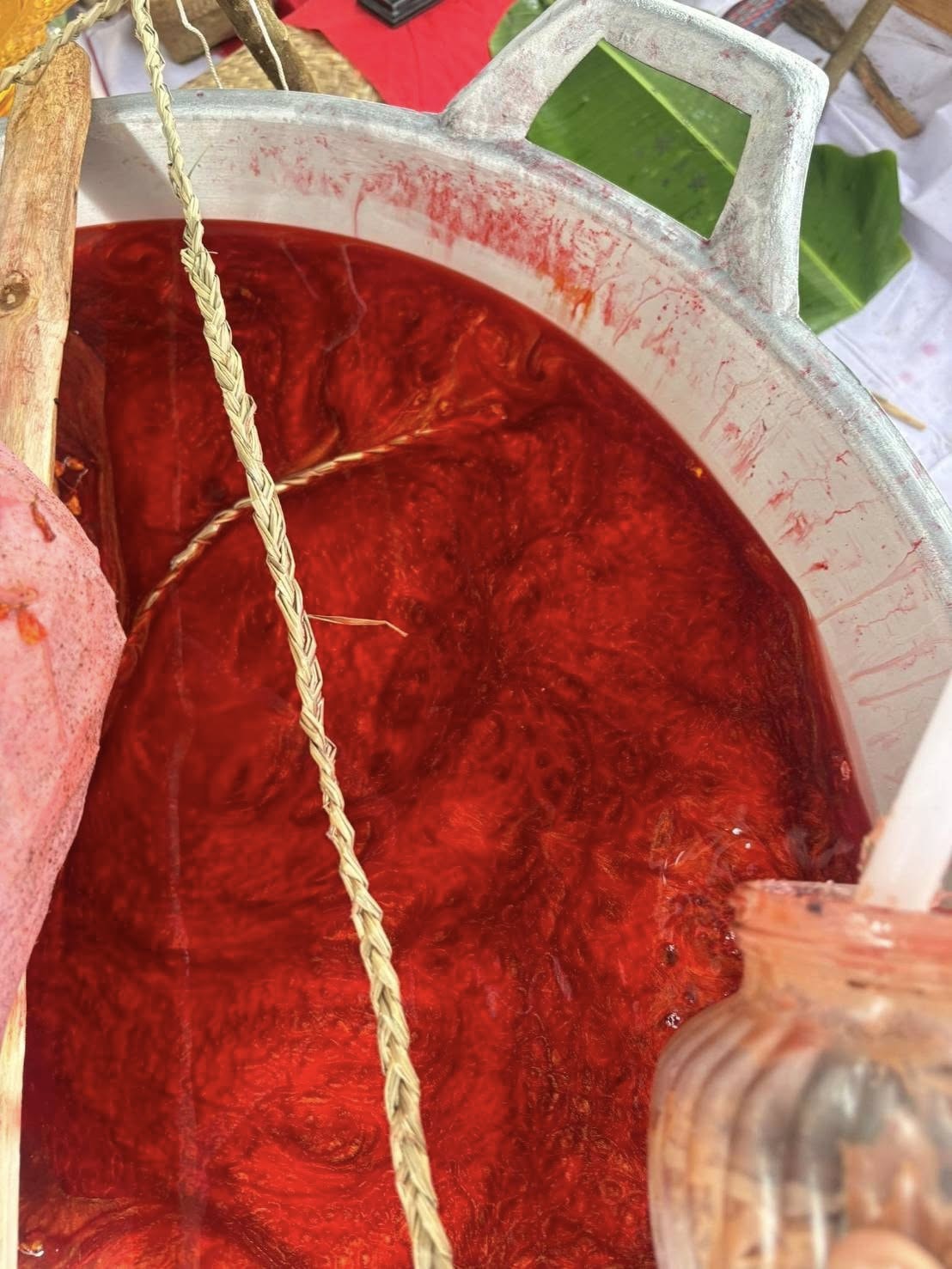Thai Blessing Co ritual pot with swirling red sacred wax and braided cord used to create Luuk Sawat sacred charm