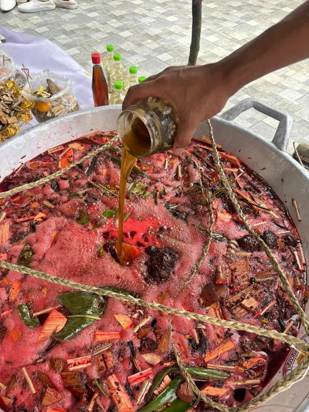 Thai Blessing Co Luuk Sawat sacred charm herbal blessing ritual pot with boiling herbs and pouring oil