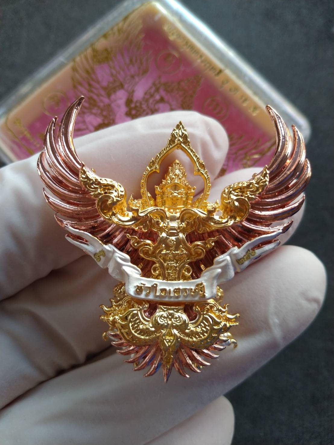 Phaya Garuda amulet for wealth ornate gold and rose gold Garuda pendant held in gloved hand Thai Blessing Co