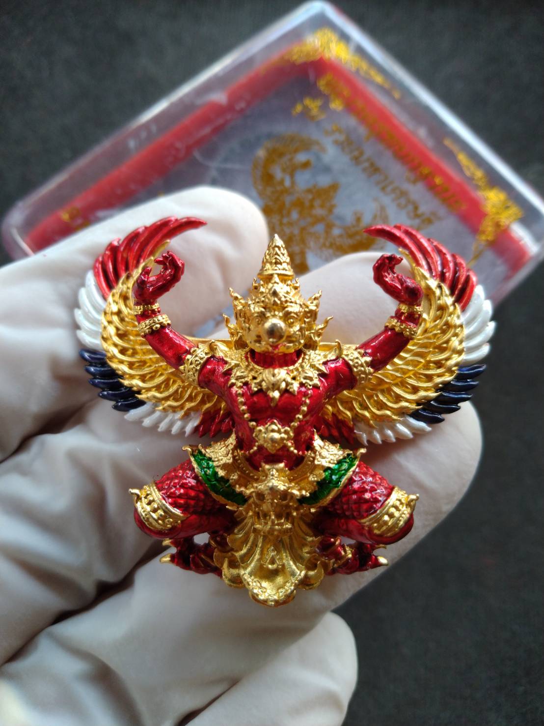 Phaya Garuda amulet for wealth gold red enamel Garuda pendant with outstretched wings held in white glove