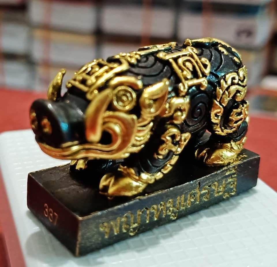 Phaya Moo Setthi black and gold ornate pig statue on base with Thai script feng shui prosperity charm