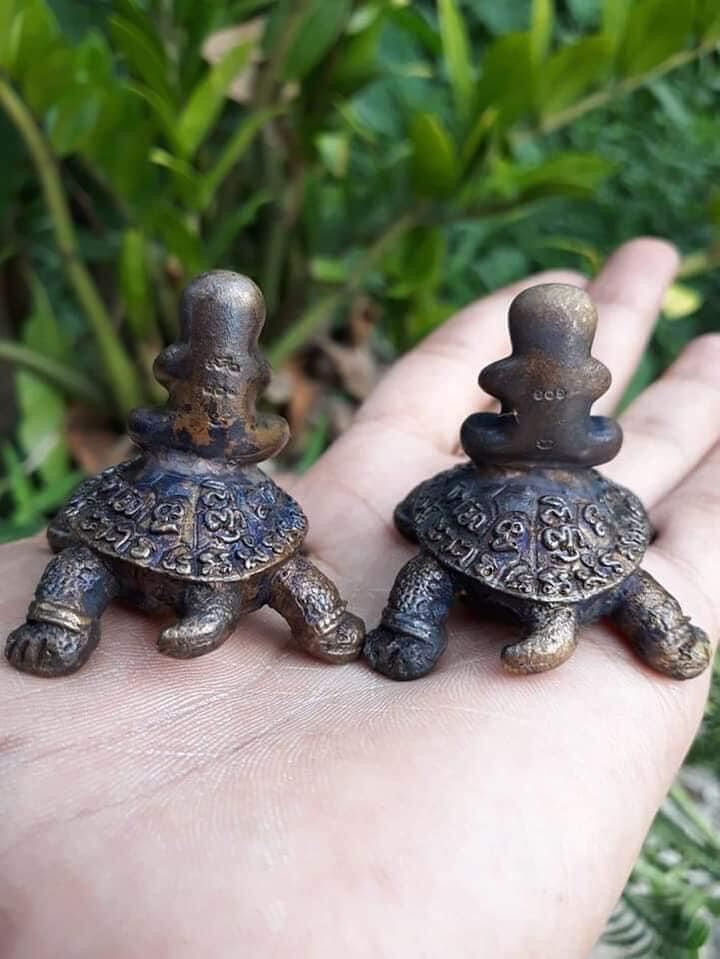 Thai Blessing Co Phaya Tao Reuan amulet for wealth pair of small bronze turtle talismans with engraved shells in hand