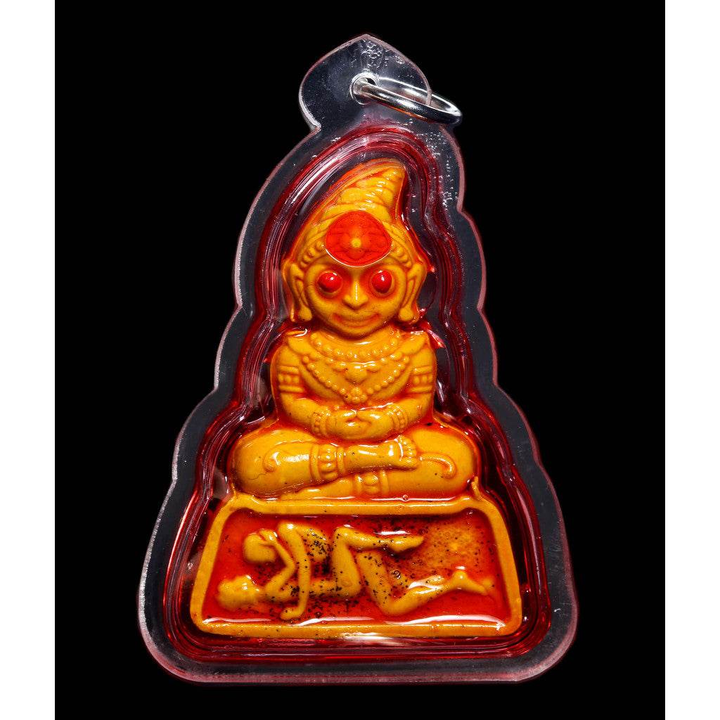 Phra Ngang love charm Thai amulet in clear casing with carved orange figure and reclining figures