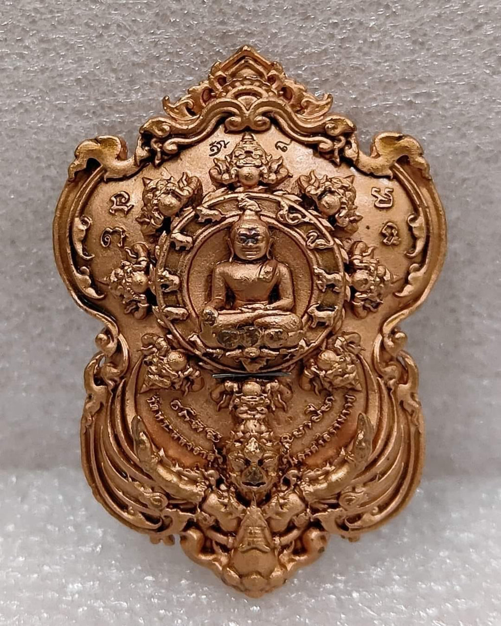 Phra Pidta amulet for wealth Thai Blessing Co ornate gold tone medallion with seated Buddha and floral motifs