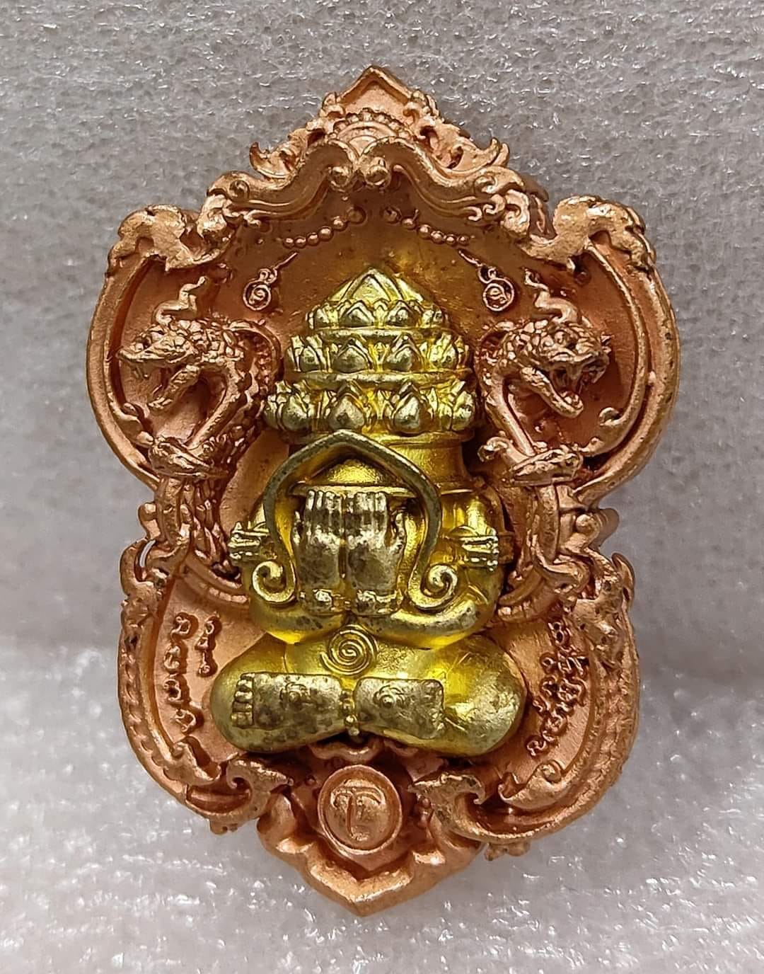 Phra Pidta amulet for wealth ornate gold and copper Thai pendant with seated covered eye Buddha in decorative frame