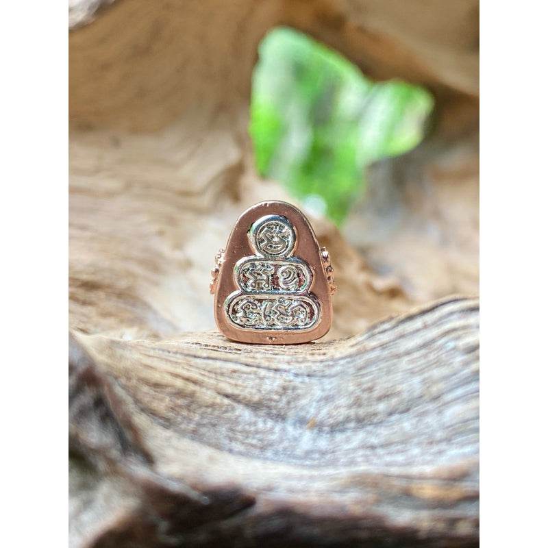 Phra Pidta Namo amulet two-tone small copper and silver Buddhist amulet with intricate engraved details on wood