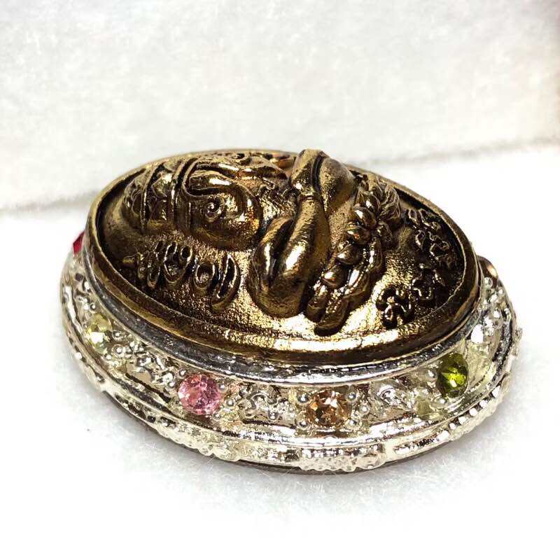 Phra Pidta nine-gem amulet billionaire edition gold toned oval amulet with nine colored gems on ornate base