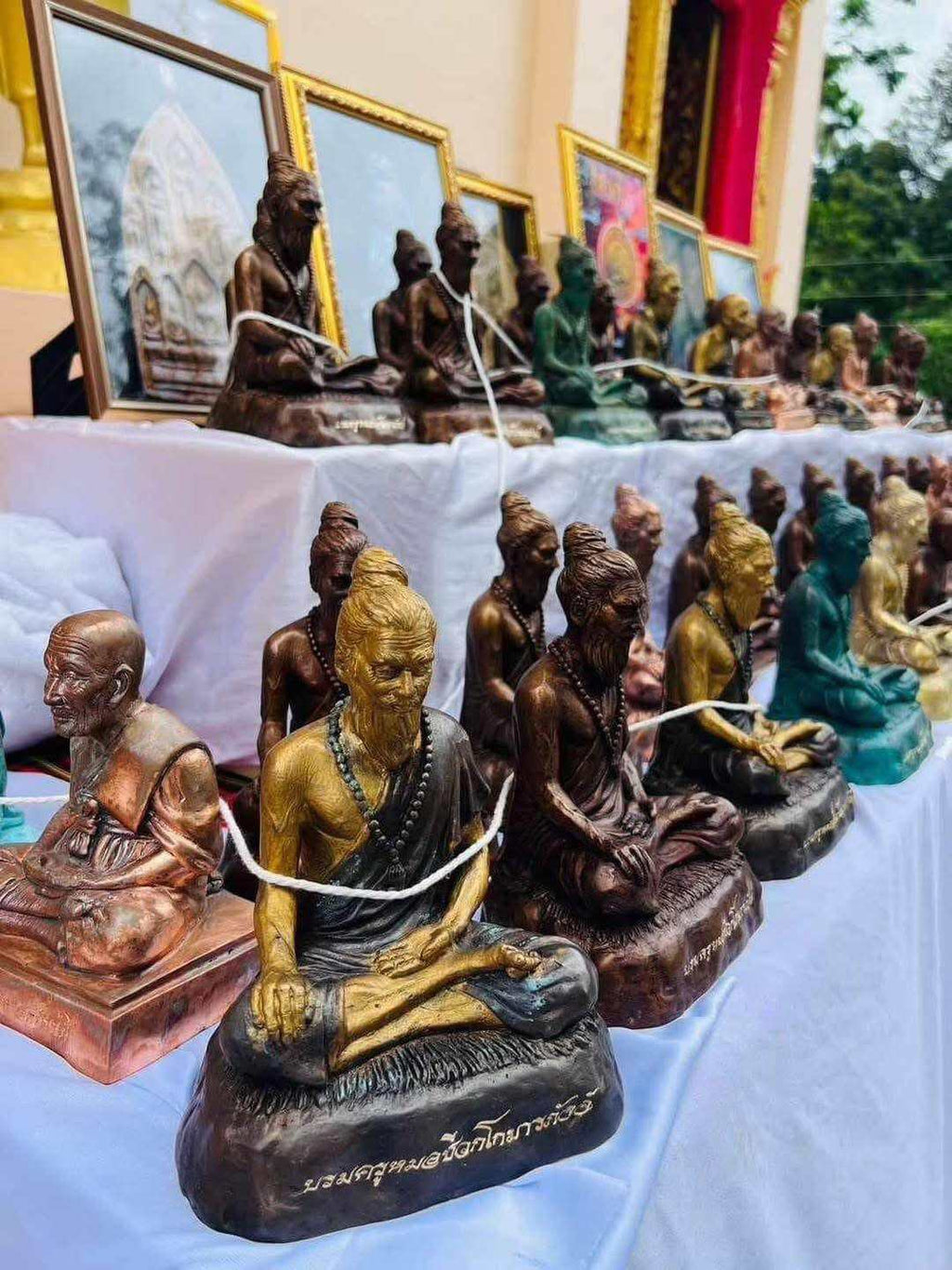 Phu Lersi Jivaka Komarabhacca statue assortment of seated hermit amulet statues in bronze and gold for altar decor