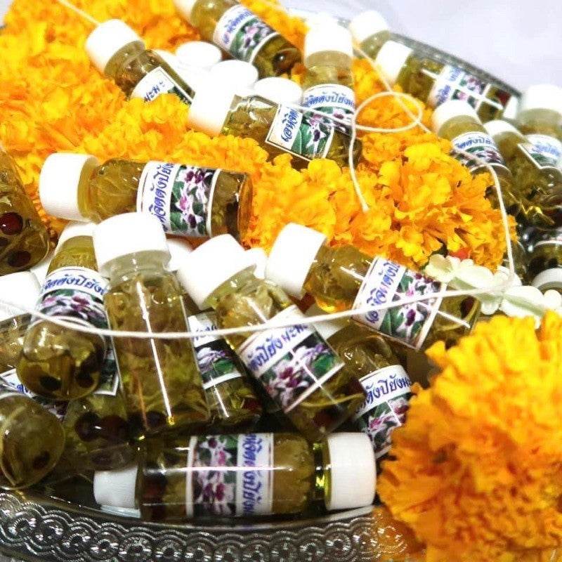 Thai Blessing Co Roi Rak Luang Ta Ruam oil for attraction small ritual oil bottles on marigold garlands
