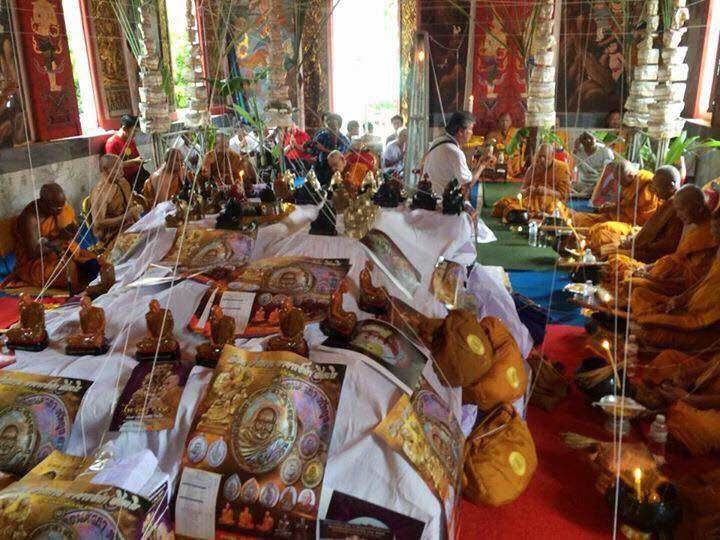 Chakkalgan Edition Thai amulet display on white cloths during temple blessing ceremony with monks