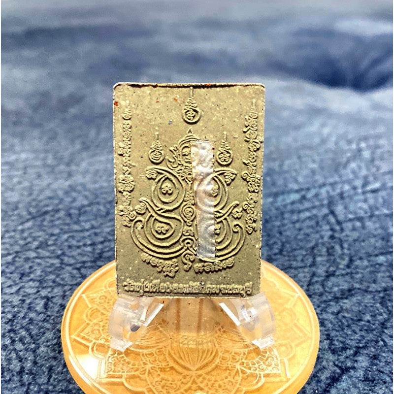 Si Sa Laeng Ngaeng amulet for protection. Thai rectangular brass yantra amulet on clear stand on gold base by Thai Blessing Co