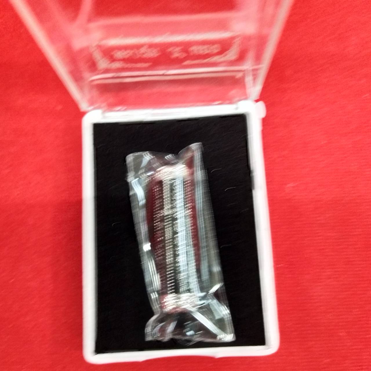 takrut 5 lines amulet by Thai Blessing Co in clear plastic display box on black foam and decorative home charm
