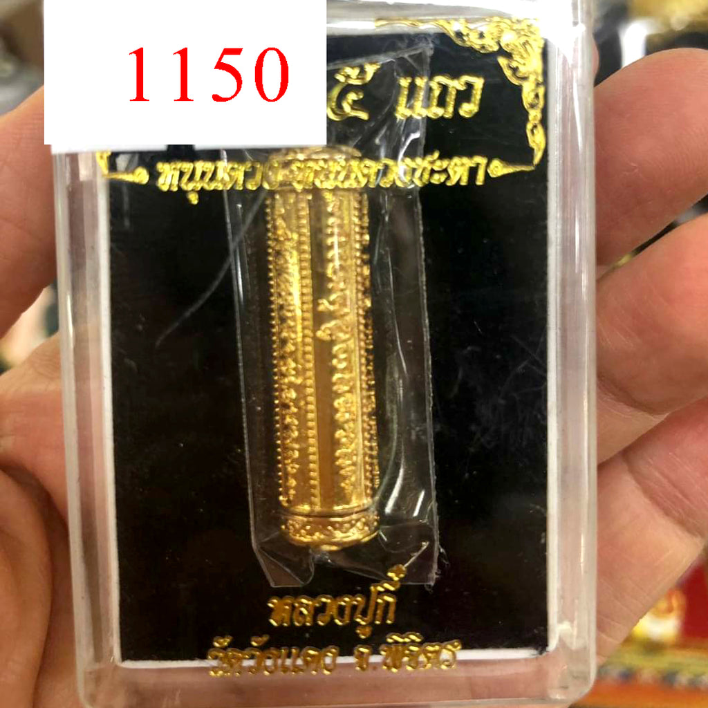 Thai Blessing Co gold engraved takrut 5 lines amulet in clear plastic display case held in hand