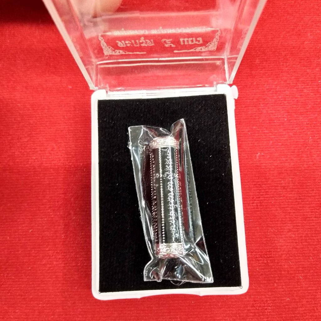 Thai Blessing Co takrut 5 lines amulet in clear plastic wrap displayed in black velvet jewelry box