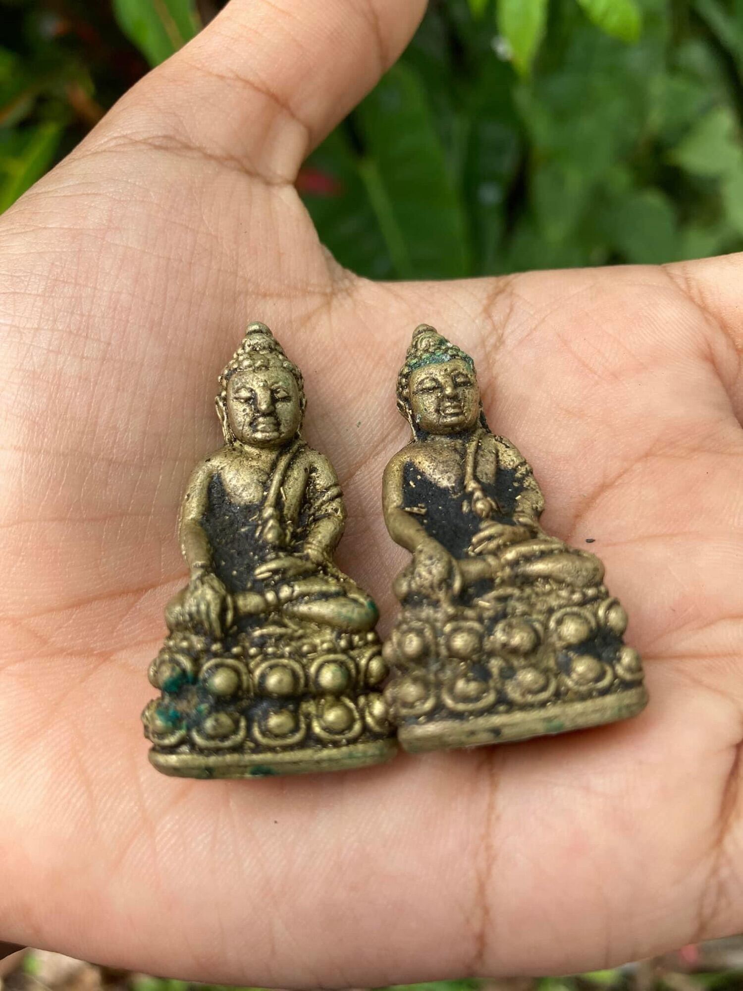 Handheld vintage brass Buddha statuettes pair from Thai Blessing Co small amulets Thai ghost-repelling amulet for protection