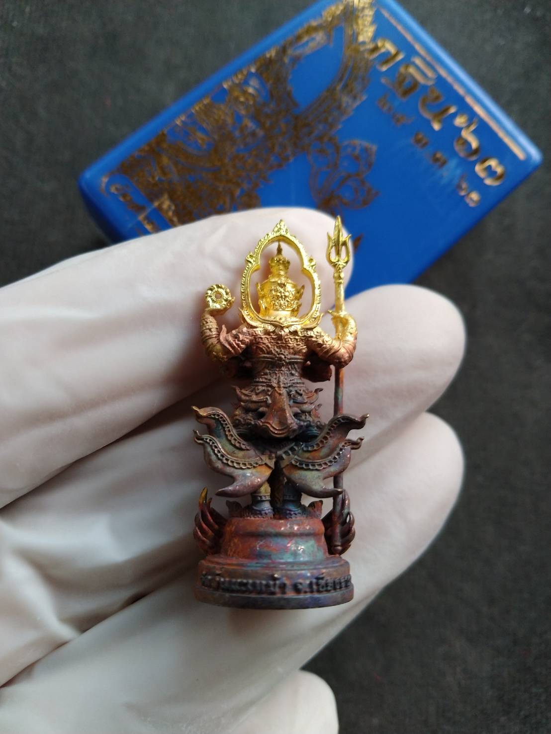 Thao Wessuwan statue for wealth and protection. Thai Blessing Co brass amulet pendant held in gloved hand