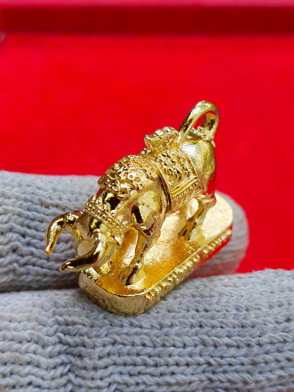 Gold Wua Ta Nhoo sacred bull talisman pendant on base with intricate Thai detailing and hanging loop