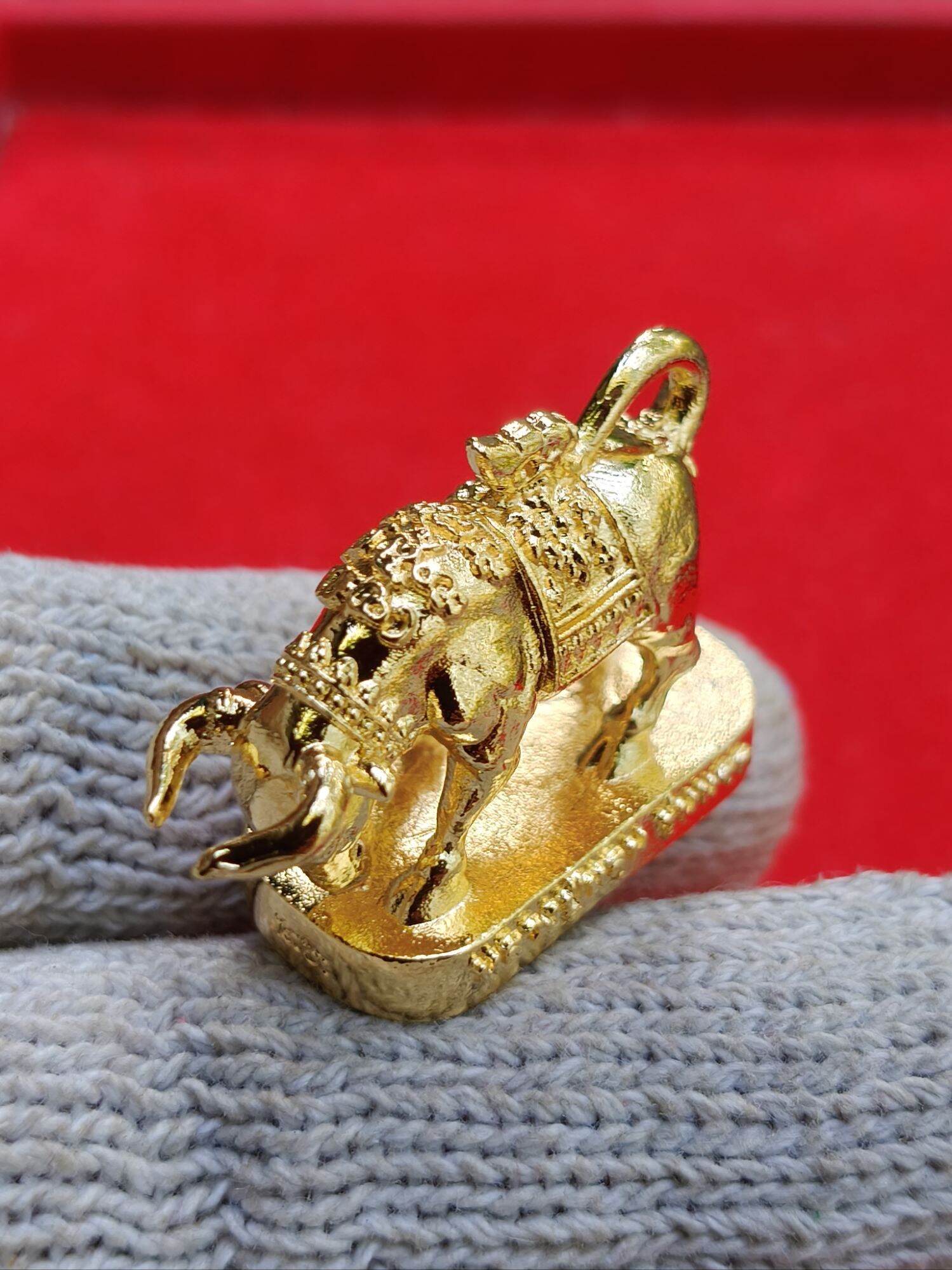 Gold Wua Ta Nhoo sacred bull talisman pendant on base with intricate Thai detailing and hanging loop