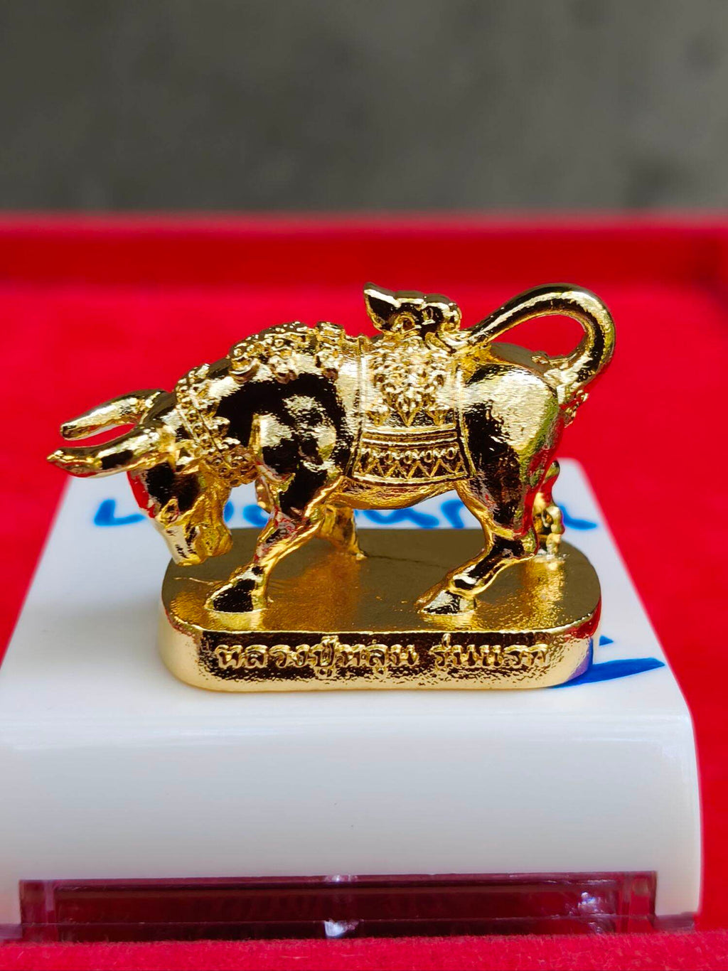 Wua Ta Nhoo sacred bull talisman gold plated amulet figurine on base with ornate Thai saddle and engraving