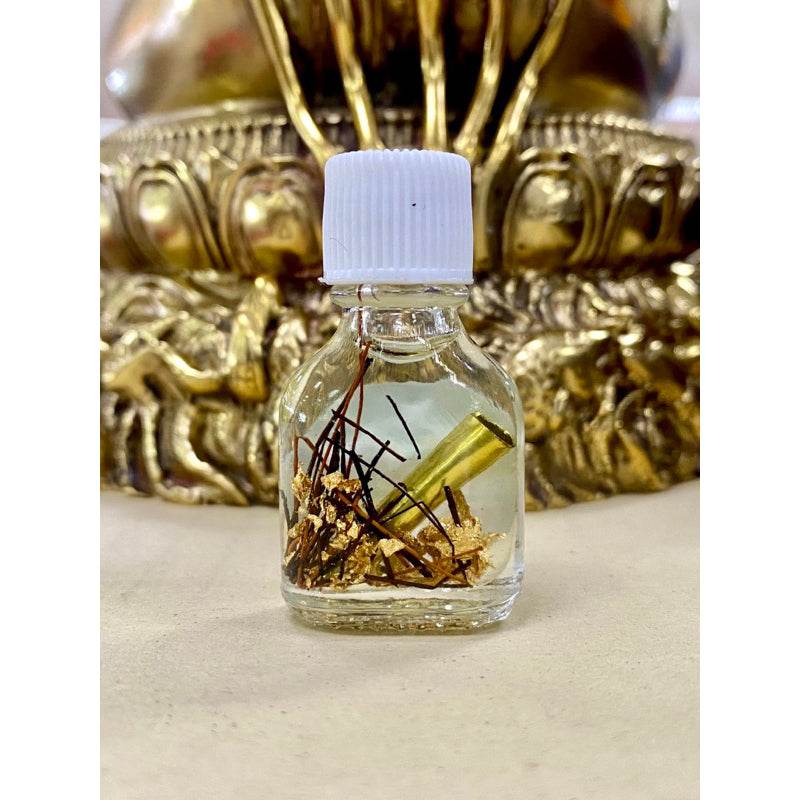 Small Thai blessing bottle with gold leaf and herbs Khao Long Charm Oil for prosperity used in rituals