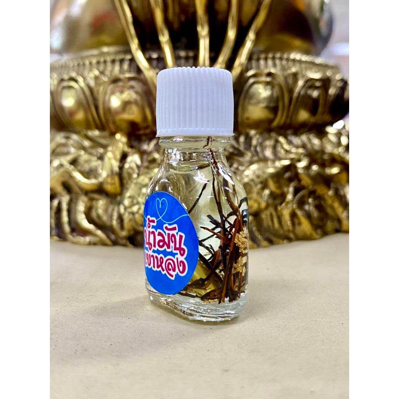 Khao Long Charm Oil for prosperity small glass bottle with herbs and white cap by Thai Blessing Co