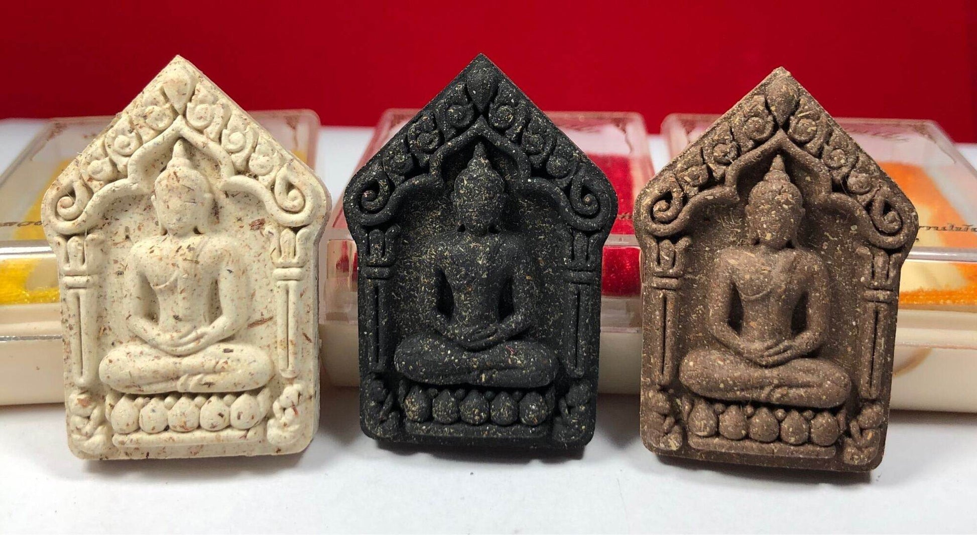 Three Phra Khun Paen Amulet - Blessed by Luang Pu Kaew, Wat Sapan Mai Kaen. small Thai amulet pendants in white black and brown