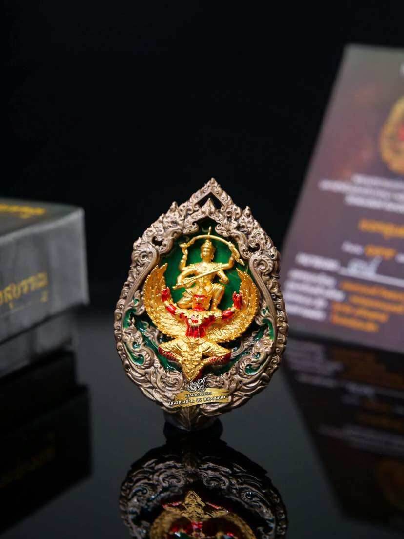 Narayana on Garuda Medallion gold and green enamel amulet with ornate silver frame on black reflective surface