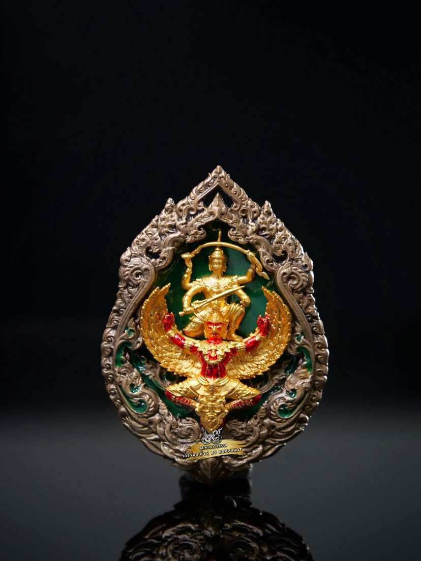 Ornate gold and red Narayana on Garuda Medallion with green enamel background and carved silver frame