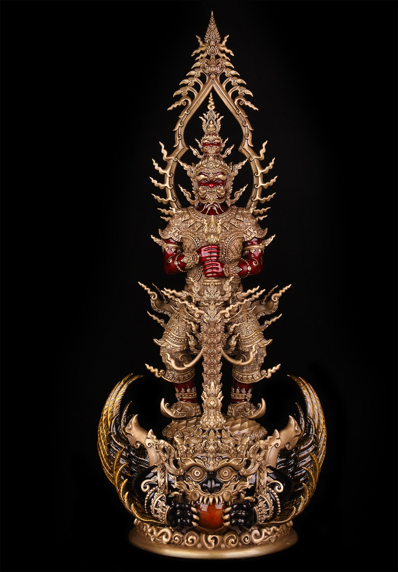 Thao Wessuwan statue for wealth and protection. Ornate gold Thai amulet statue with red accents and intricate carvings