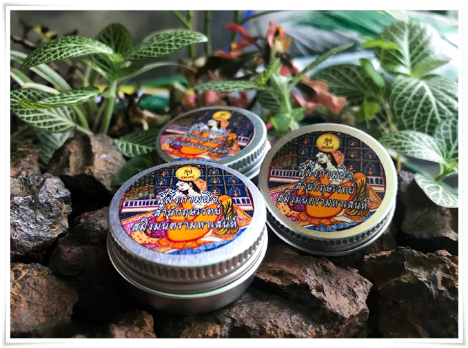 Thai attraction charm balm in decorative tins featuring traditional Thai art and vibrant colors