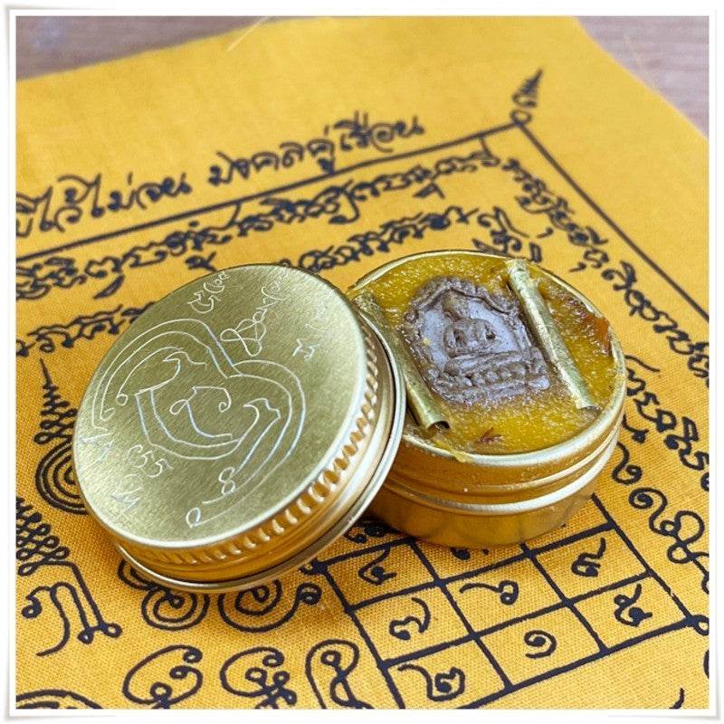 Thai Blessing Co Thai beeswax balm for pain relief in decorative gold container with an ornate lid
