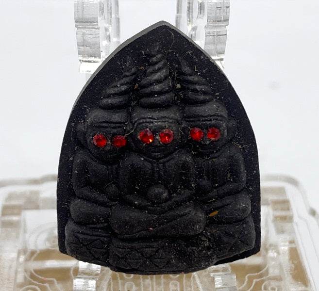 Thai blessed love and money talisman showcasing intricate design with red gemstones for good fortune