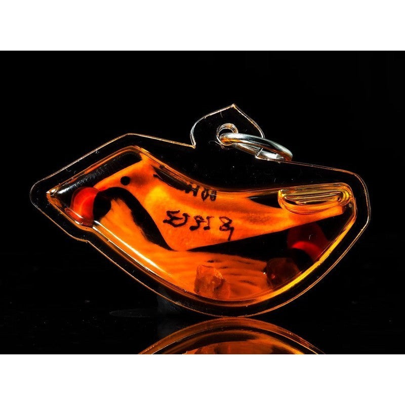 Thai blessed lucky charm bird amulet in orange with black script by Thai Blessing Co