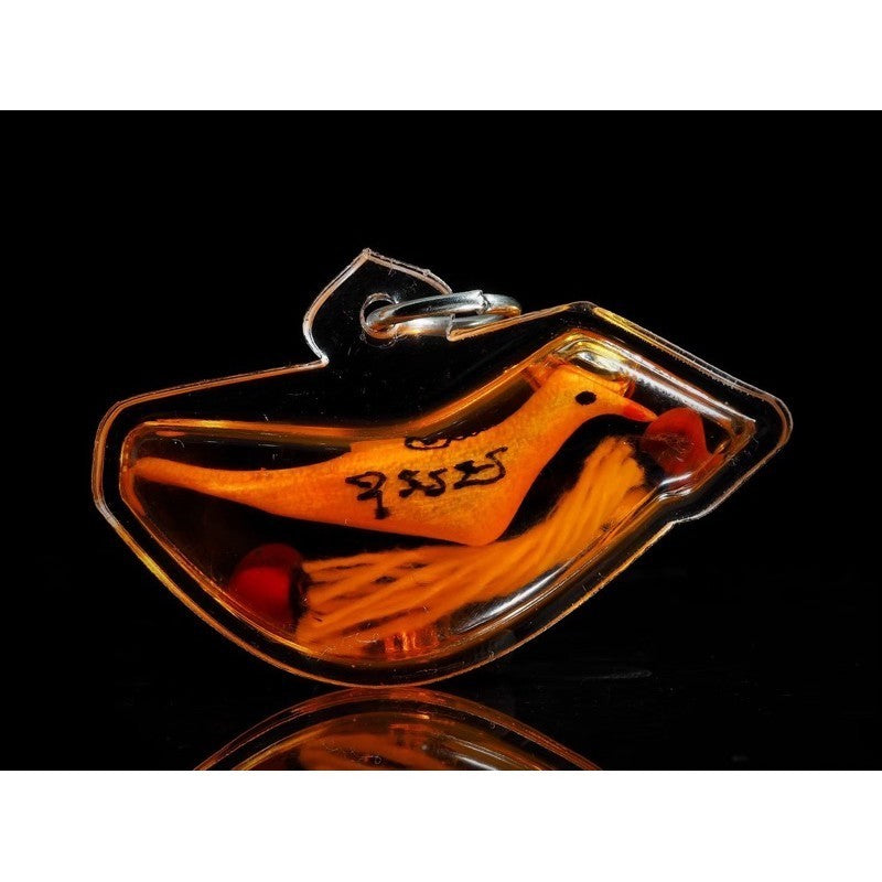 Thai blessed lucky charm in bird shape encased in clear protective casing by Thai Blessing Co