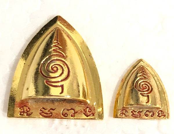 Set of Thai blessed talisman good luck amulets in gold with intricate designs for prosperity