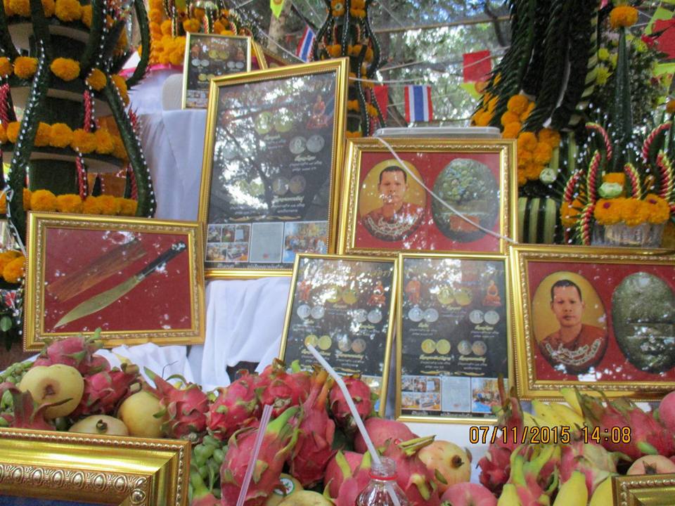 Beautiful display of Phra Ajarn Tee Lek sacred locket alongside framed images and offerings