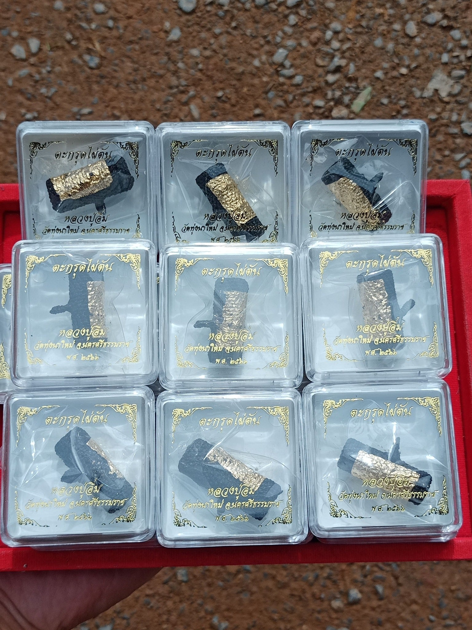 Thai Blessing Co Takrut Phai Tan amulet for protection. Nine gold leaf takrut scrolls in clear display boxes