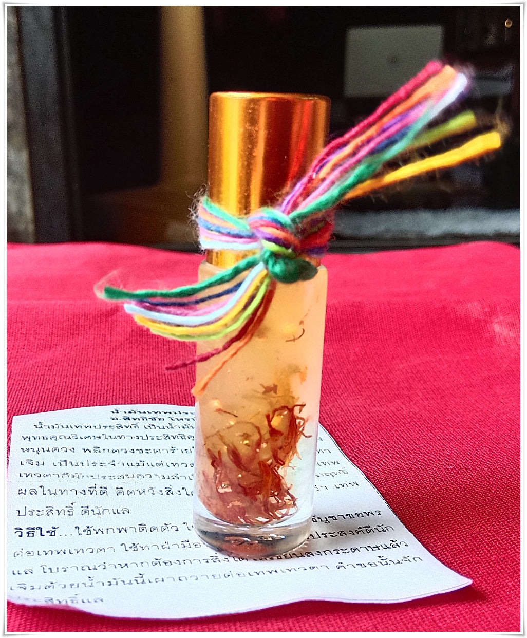 Thai Blessing Co glass roll on bottle with herbs and multicolor string for thai buddhist fortune oil