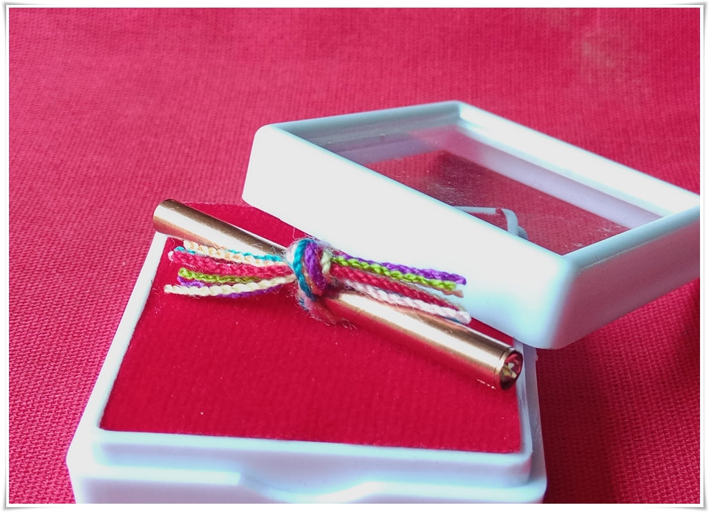 Fortune boosting Thai talisman in a decorative box with colorful threads for positive energy