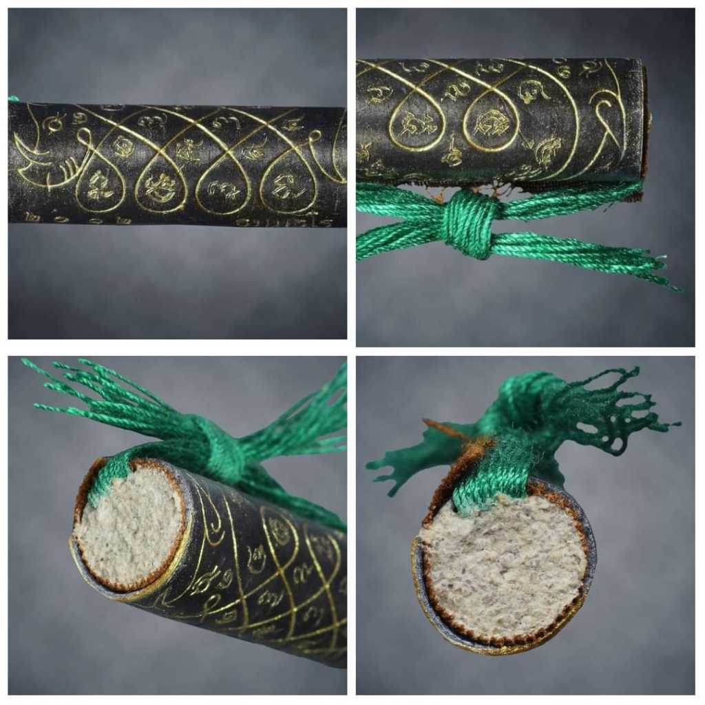 Thai boar talisman for luck with intricate gold script on black fabric and green woven string