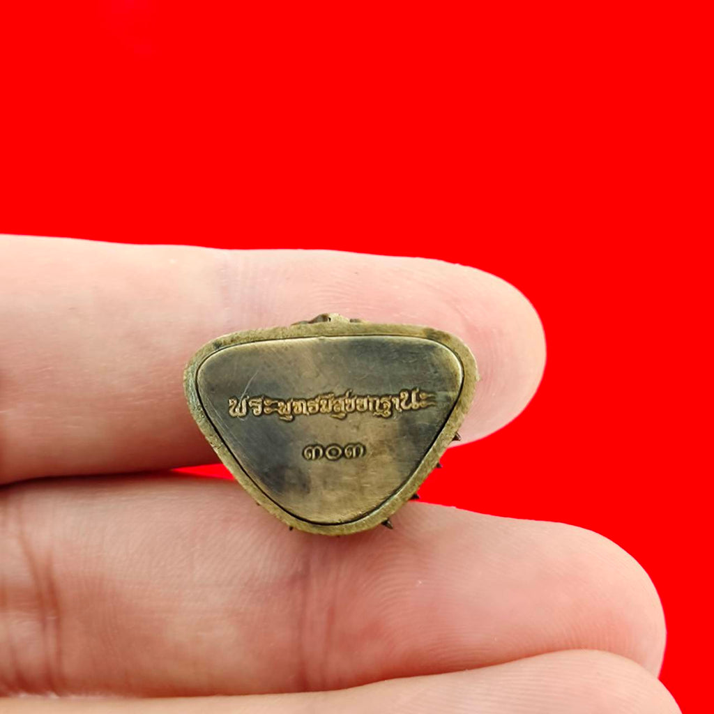 Thai Buddha amulet blessed by Luang Por Weera held in hand, showcasing detailed craftsmanship and spiritual significance