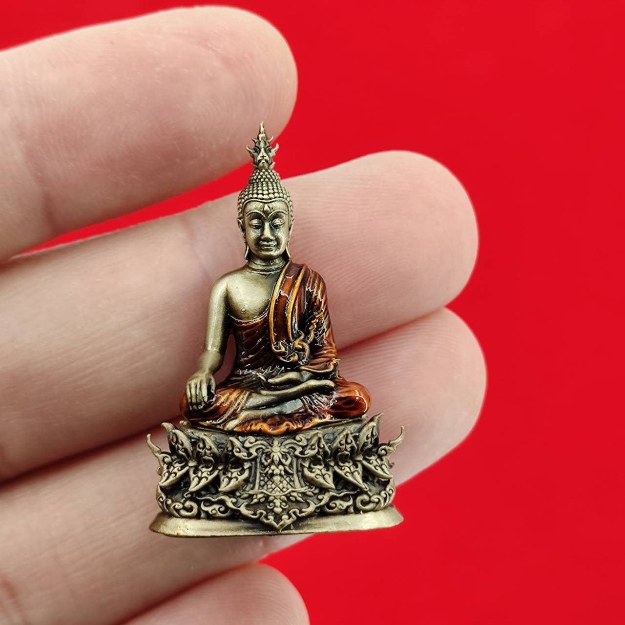Thai Buddha amulet blessed by Luang Por Weera, hand-held statue with detailed craftsmanship and rich colors