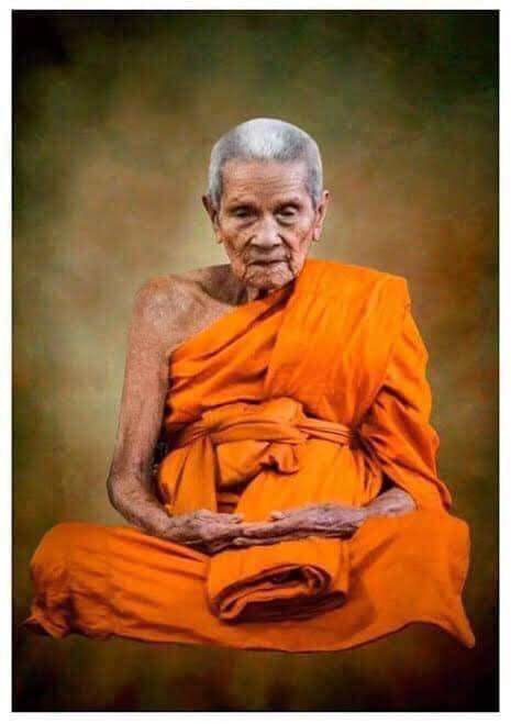 Elderly Buddhist monk in orange robes representing Thai Buddha debt release amulet for spiritual protection