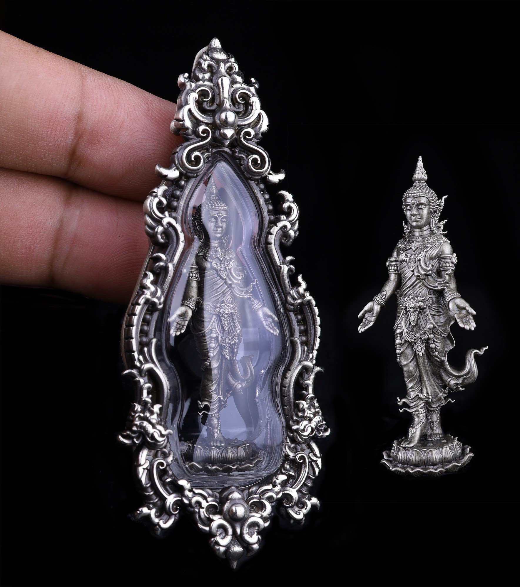Thai Buddhist lucky charm pendant in ornate silver frame showcasing a detailed figure of a deity