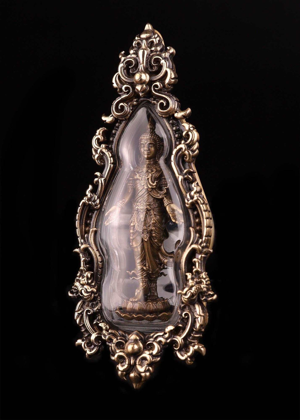 Ornate Thai Buddhist lucky charm featuring a protective figure encased in decorative glass and metal frame
