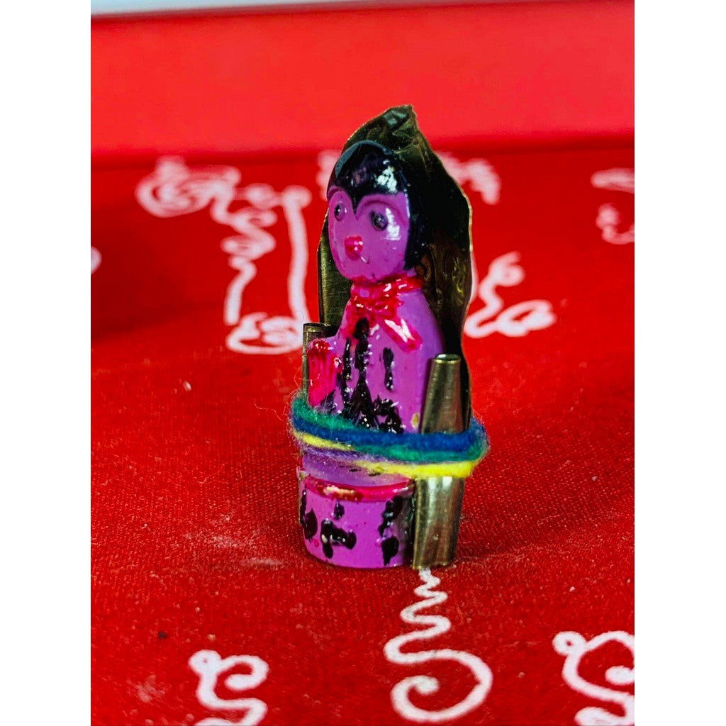 Thai business prosperity amulet in purple with colorful thread and gold accents on red background