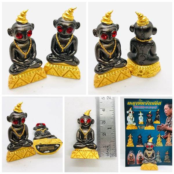 Thai charm amulet for luck featuring a decorative black statue with golden accents and red eyes.
